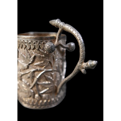 24 - A eastern white metal tankard and a vesta case, both with foliate decoration, tankard 11 by 6.5 by 1... 