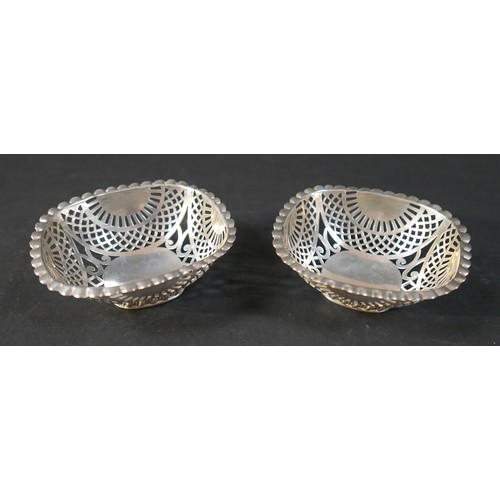 31 - A collection of silver items, comprising two jugs, four napkin rings, a salt and a pair of silver sw... 