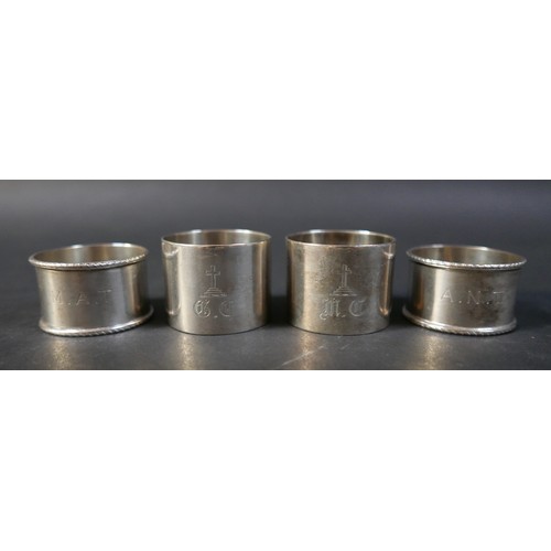 31 - A collection of silver items, comprising two jugs, four napkin rings, a salt and a pair of silver sw... 