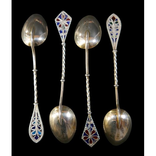 26 - Eleven items of silver, comprising four plique a jour spoons, a page mark, two rattles, a pot , lett... 