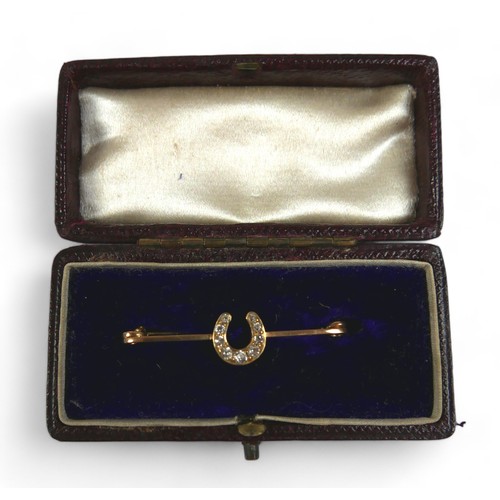 124 - Three gold brooches, comprising a platinum 15ct yellow gold riding crop, 6cm long, a diamond horsesh... 