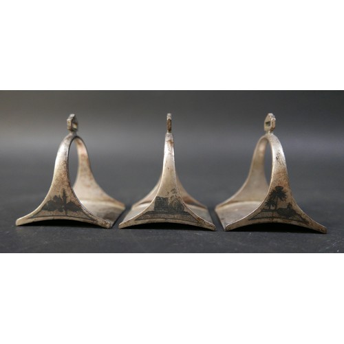 16 - A set of six Egyptian niello white metal stirrup shaped napkin rings, each 5 by 4 by 6cm high. (6)