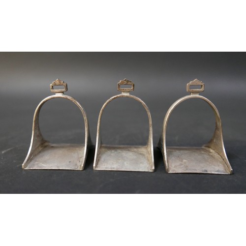 16 - A set of six Egyptian niello white metal stirrup shaped napkin rings, each 5 by 4 by 6cm high. (6)