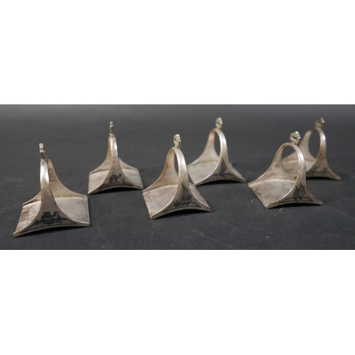 16 - A set of six Egyptian niello white metal stirrup shaped napkin rings, each 5 by 4 by 6cm high. (6)