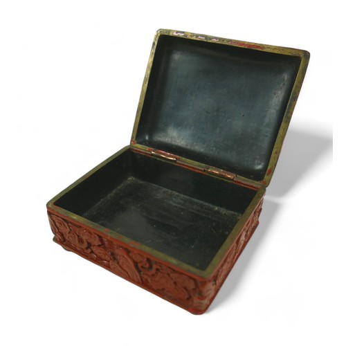 173 - An early 20th century Chinese Cinnabar lacquer jewellery box, of rectangular form with domed hinged ... 