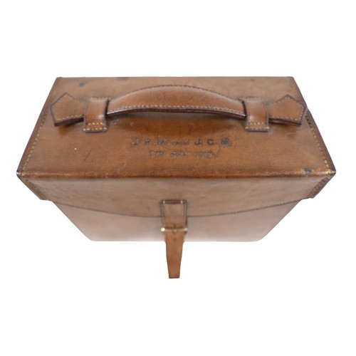 388 - A tan leather gentleman's travel case with a fitted interior containing a pair of silver hunting top... 