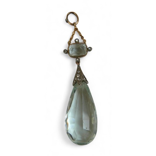 129 - A gold pear shaped cushion cut two part drop pendant set with small diamonds (possibly aquamarine), ... 