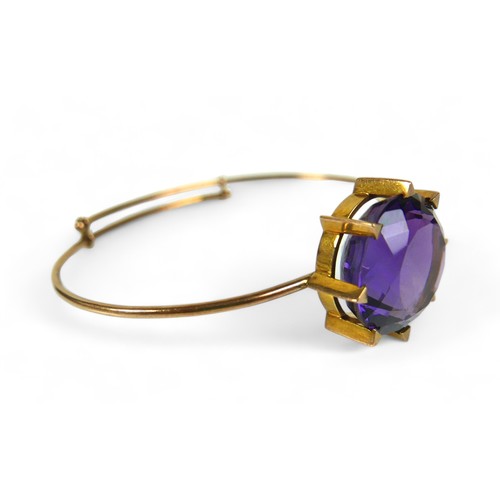 145 - An amethyst and 15ct gold bangle, the bracelet with large single large round-cut purple amethyst, 20... 