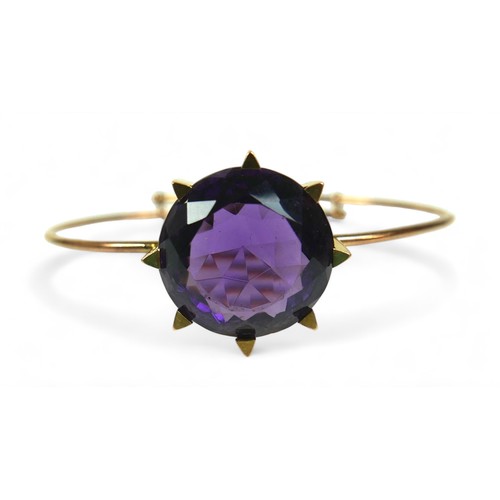 145 - An amethyst and 15ct gold bangle, the bracelet with large single large round-cut purple amethyst, 20... 