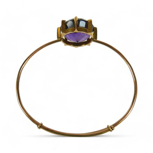 145 - An amethyst and 15ct gold bangle, the bracelet with large single large round-cut purple amethyst, 20... 