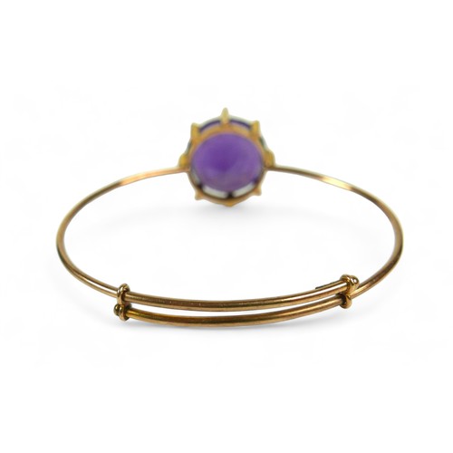 145 - An amethyst and 15ct gold bangle, the bracelet with large single large round-cut purple amethyst, 20... 