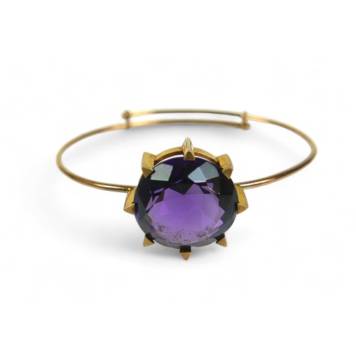 145 - An amethyst and 15ct gold bangle, the bracelet with large single large round-cut purple amethyst, 20... 