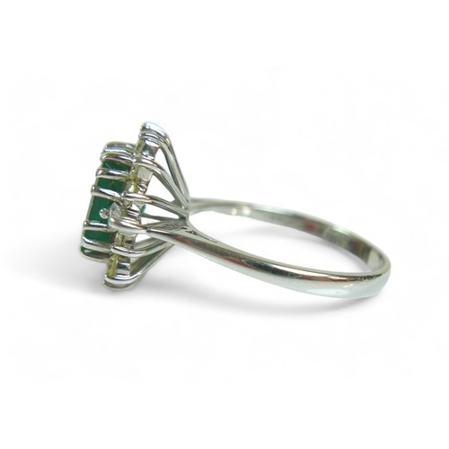 147 - A square-cut emerald and diamond ring, the central dark green emerald approx 8mm by 8mm, surrounded ... 