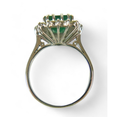 147 - A square-cut emerald and diamond ring, the central dark green emerald approx 8mm by 8mm, surrounded ... 