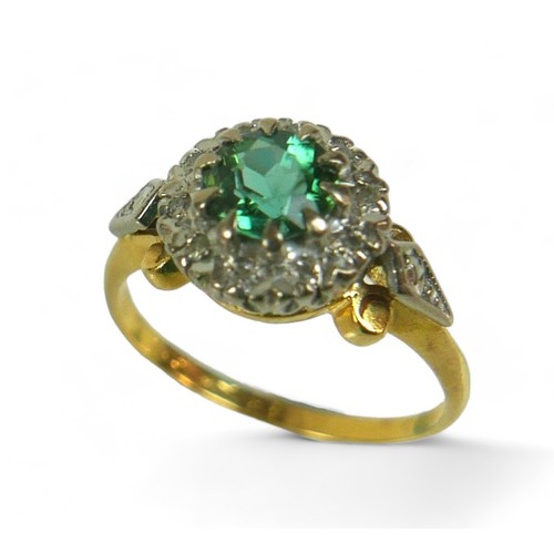 130 - A diamond and green stone flowerhead cluster ring, possibly green tourmaline, the round-cut central ... 