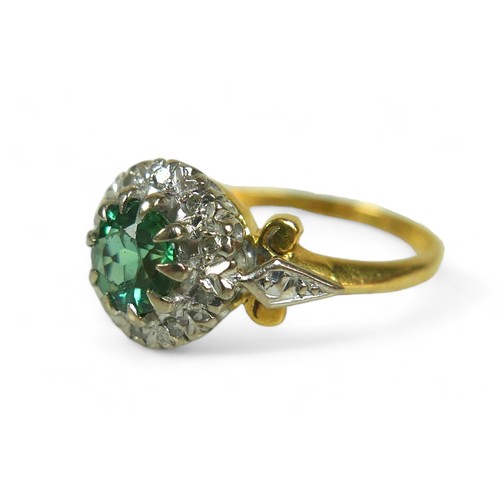 130 - A diamond and green stone flowerhead cluster ring, possibly green tourmaline, the round-cut central ... 