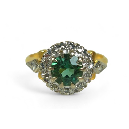 130 - A diamond and green stone flowerhead cluster ring, possibly green tourmaline, the round-cut central ... 