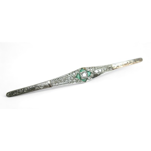 148 - An Art Deco diamond and emerald bar brooch, on 18ct gold and platinum setting, the central round cut... 