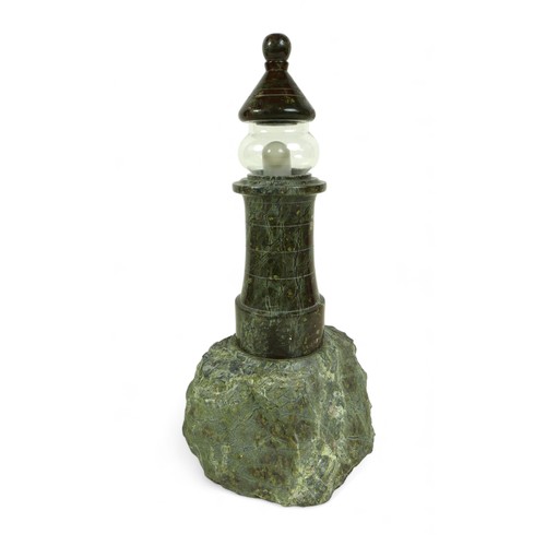 391 - A serpentine table lamp, in the form of a lighthouse, with replacement glass, 15 by 15 by 33cm high.