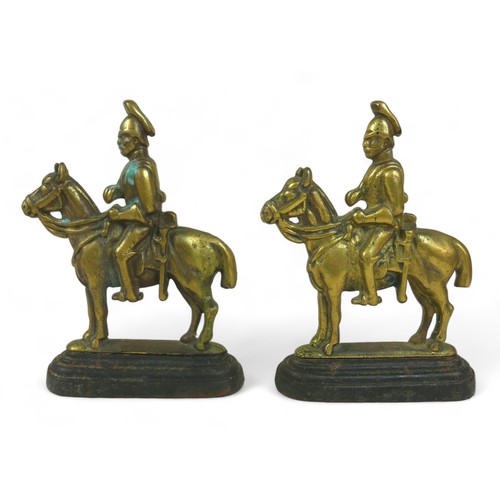 364 - A pair of brass and iron doorstops, in the form of cavalry soldiers, 18 by 5 by 26cm high. (2)