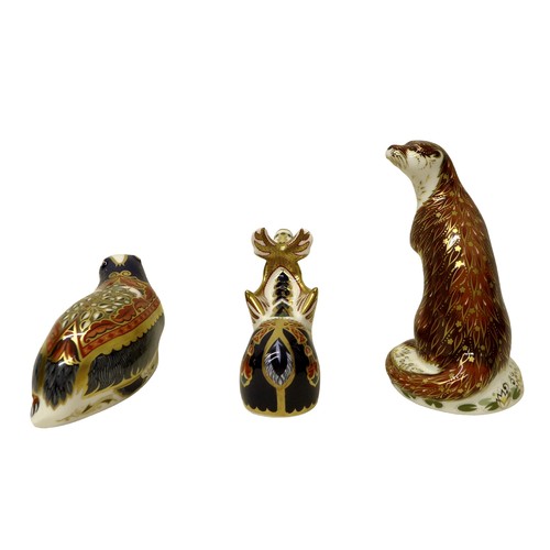 225 - A group of three boxed Royal Crown Derby paperweights, comprising Reindeer, Playful Otter for (Conna... 