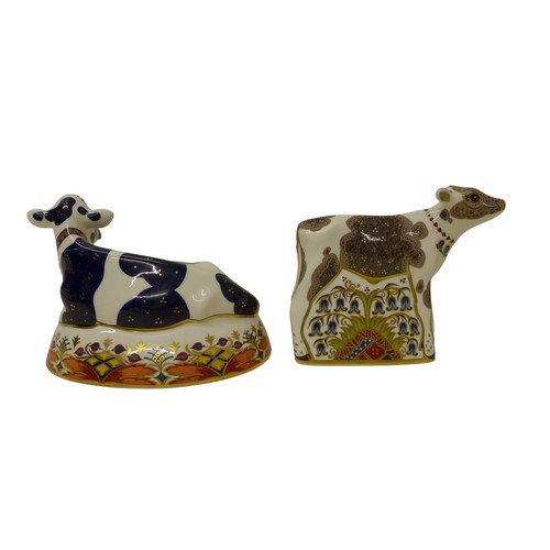 207 - Two boxed Royal Crown Derby paperweights, 'Buttercup' Friesian Cow, a/f, 'Bluebell' Calf, both with ... 