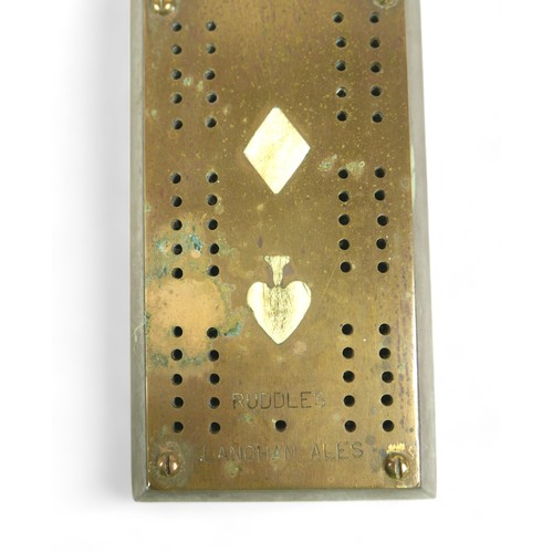 325 - A brass cribbage board, inset with bone plaques of the four suits, stamped 'The Millstone Inn' and '... 