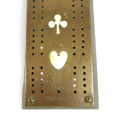 325 - A brass cribbage board, inset with bone plaques of the four suits, stamped 'The Millstone Inn' and '... 