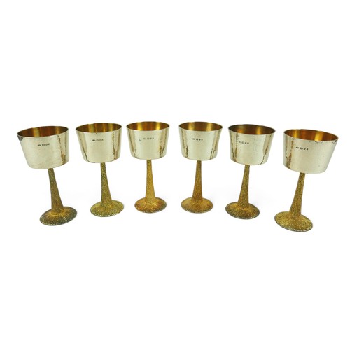 1 - A set of six Stuart Devlin silver goblets, the bowls decorated with hammered finish, gilt interior, ... 