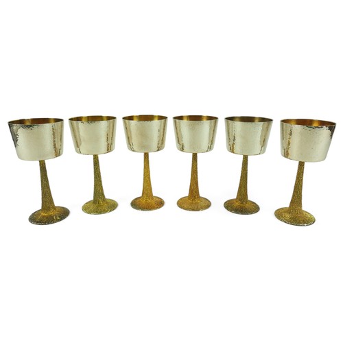 1 - A set of six Stuart Devlin silver goblets, the bowls decorated with hammered finish, gilt interior, ... 