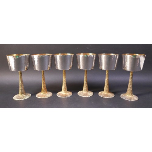 1 - A set of six Stuart Devlin silver goblets, the bowls decorated with hammered finish, gilt interior, ... 