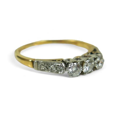 136 - An 18ct gold three stone diamond ring, with additional small diamonds to the shoulders, size U, the ... 