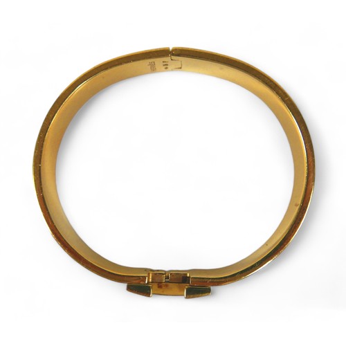 117 - A Hermes Clac H gold plated hinged bangle, with blue enamel details, H design clasp.