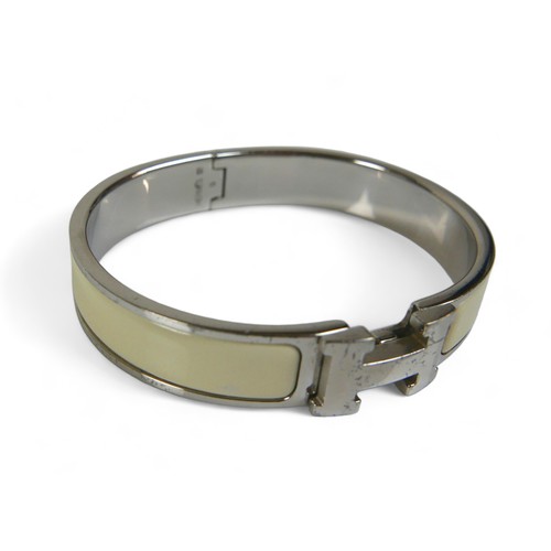 118 - A Hermes Clac H hinged bangle, with silver metal and cream enamel details, H design clasp.