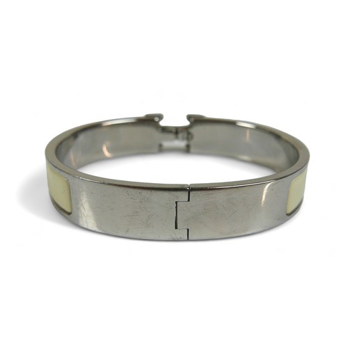 118 - A Hermes Clac H hinged bangle, with silver metal and cream enamel details, H design clasp.