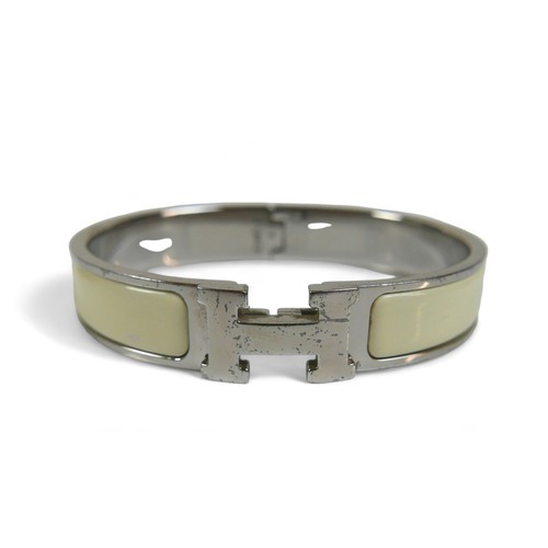 118 - A Hermes Clac H hinged bangle, with silver metal and cream enamel details, H design clasp.