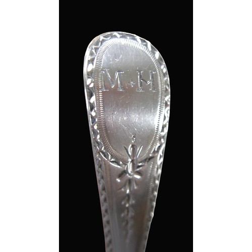 29 - Two George III silver spoons, comprising a large fiddle back pattern basting spoon, monogram to the ... 