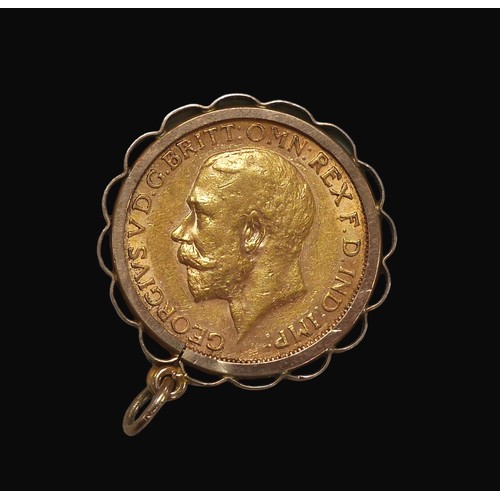 65 - A George V gold sovereign, 1911, with yellow metal mount, 9.8g overall.