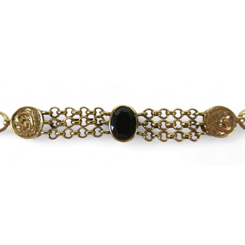 125 - A 9ct yellow gold fancy watch chain link bracelet set with a single garnet, 20.5 by 3cm, 20.2gs.