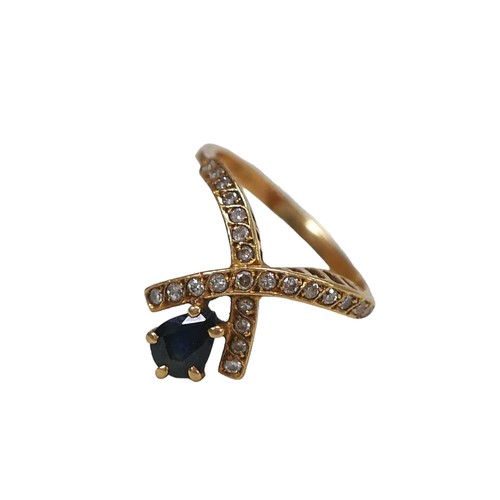 91 - An 18ct gold sapphire and diamond crossover ring, pear cut sapphire approximately 5 by 4mm, size H/I... 