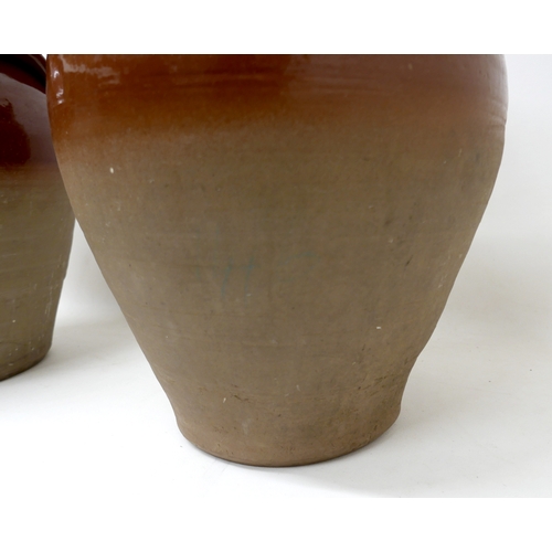 212 - A pair of early 20th century stoneware salting pots, with brown glaze to upper body, moulded applied... 