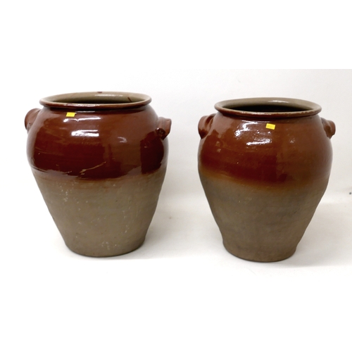 212 - A pair of early 20th century stoneware salting pots, with brown glaze to upper body, moulded applied... 