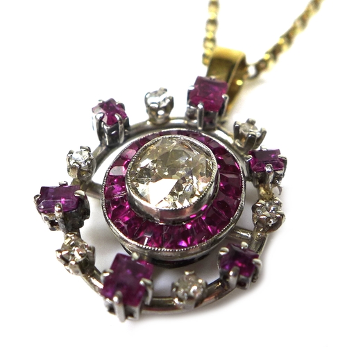 134 - A diamond and ruby pendant, formed of a central old oval cut diamond, 6.1 by 5.3 by 3.4mm, approxima... 