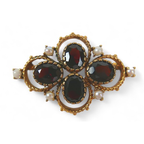 127 - A Victorian gold, garnet and pearl brooch, set with four oval garnets and six pearls on fancy ropetw... 