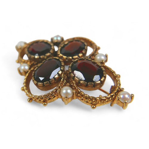 127 - A Victorian gold, garnet and pearl brooch, set with four oval garnets and six pearls on fancy ropetw... 