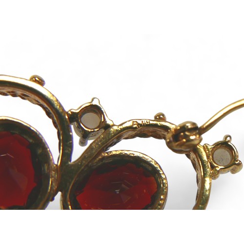 127 - A Victorian gold, garnet and pearl brooch, set with four oval garnets and six pearls on fancy ropetw... 