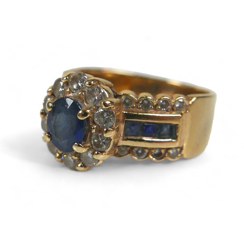 139 - A 14k gold, sapphire and diamond ring, the oval central blue sapphire surrounded by a flowerhead of ... 