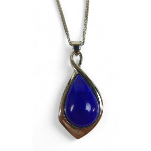 140 - An 18ct white gold and lapis lazuli pendant and chain, the teardrop cabochon blue central stone rppo... 