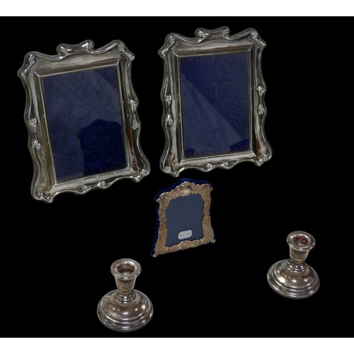 14 - A collection of ERII silver, comprising three photograph frames, including an associated pair, Carr'... 