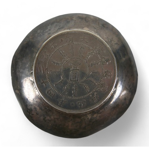 63 - A silver Chinese Pei Yang coin dish, 6.5 cm diameter by 1cm high, 39.7gs.